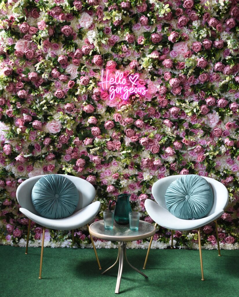 Pink flower wall with two pale blue chairs