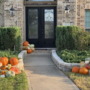 light brown brick house with pumpkins